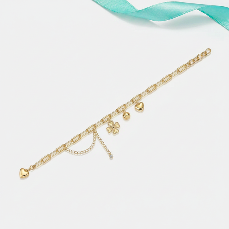 Gold bracelet with charms on a light blue background
