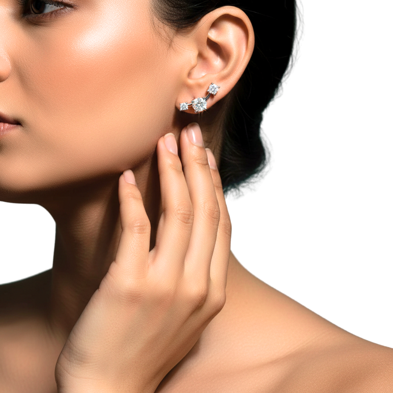 Close-up of a woman wearing diamond earrings with a neutral background