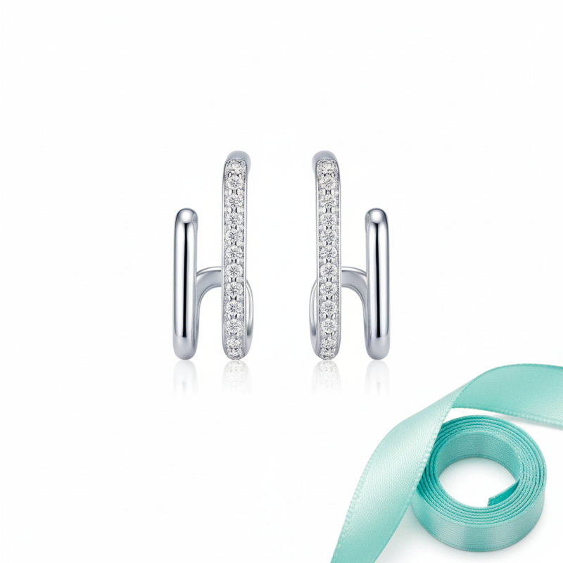 Silver hoop earrings with small diamonds on a white background with a light blue ribbon.