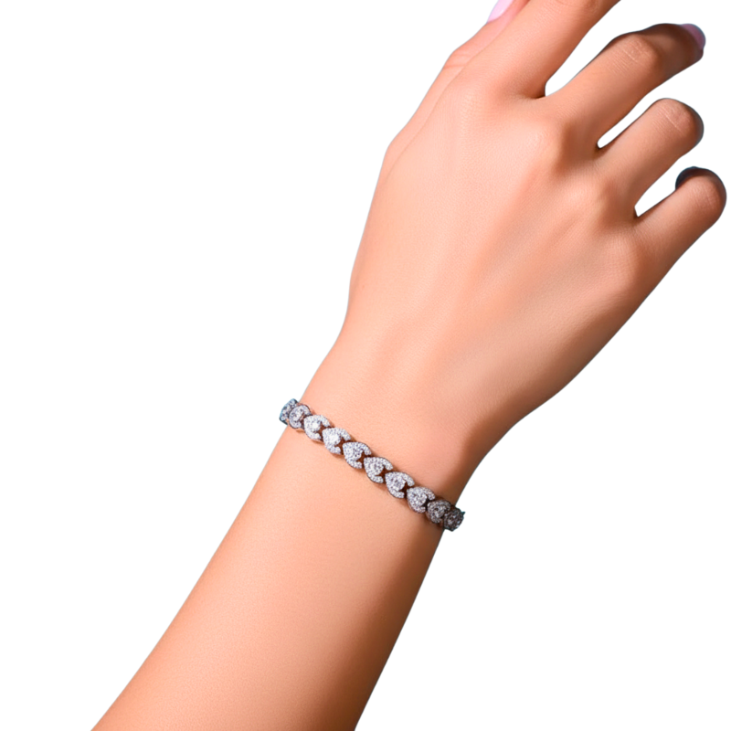 Bracelet with heart-shaped stones on a wrist against a white background