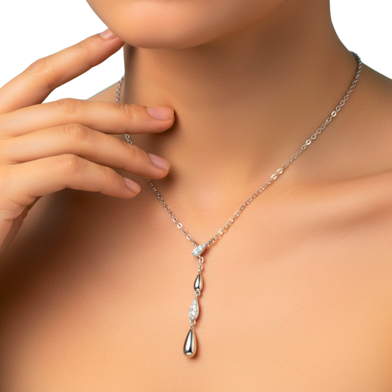 Silver necklace with a pendant on a model against a neutral background