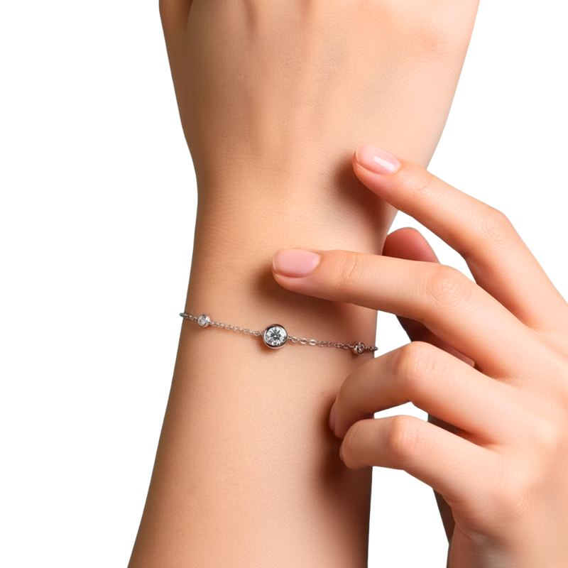 Silver bracelet with a diamond on a wrist against a white background