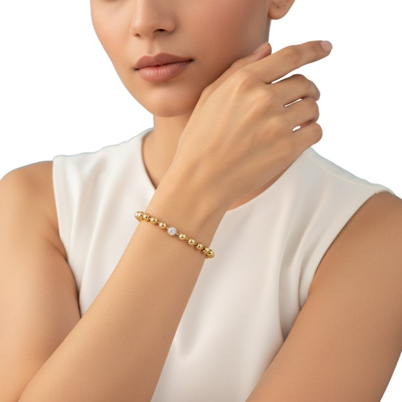 Woman wearing a gold bracelet on a white background