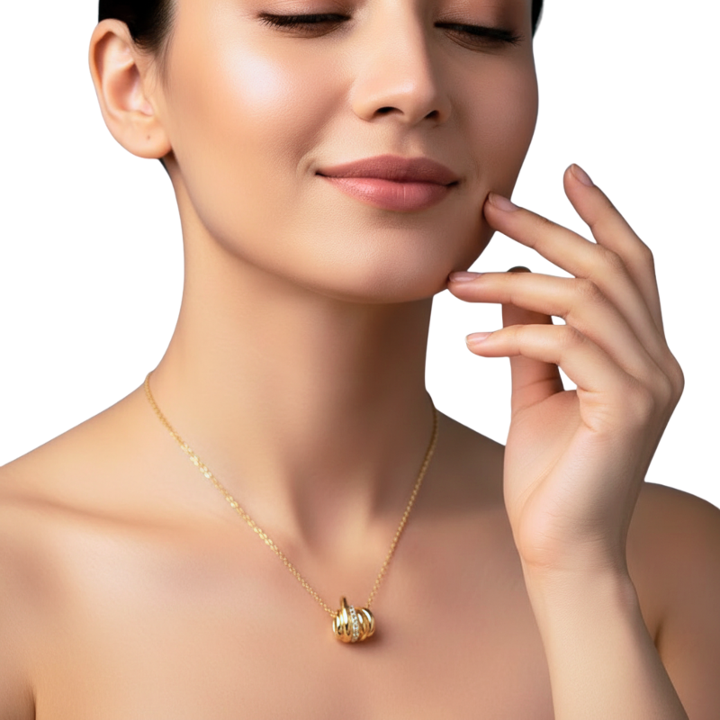 Woman wearing a gold necklace with a pumpkin pendant on a white background