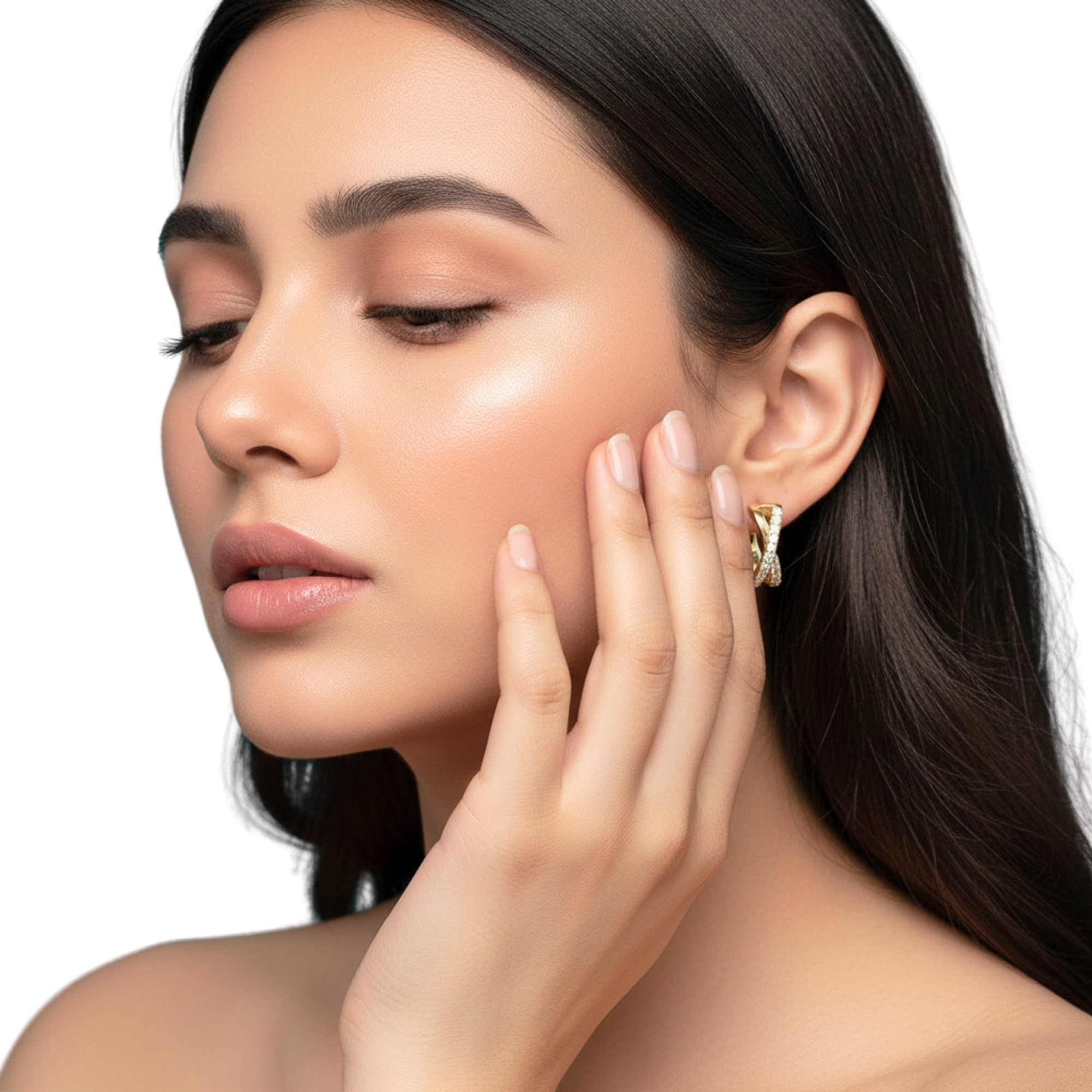 Woman wearing a gold earring with a diamond, touching her face.
