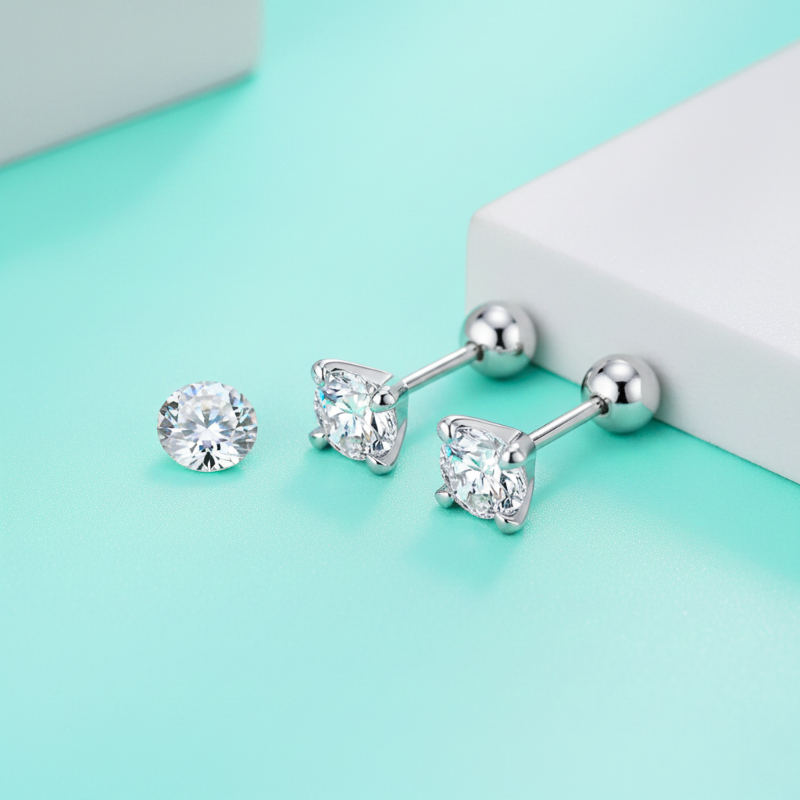 Set of silver stud earrings on a light blue background