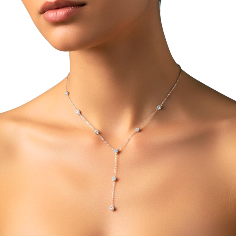 Necklace with small stones worn by a model on a neutral background