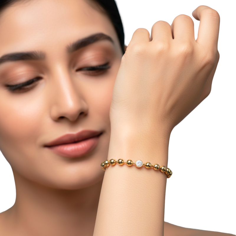 Woman wearing a gold bracelet on a white background