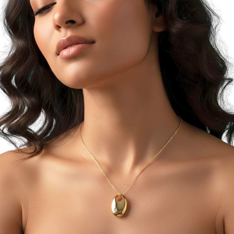 Close-up of a woman wearing a gold necklace with a pendant on a white background