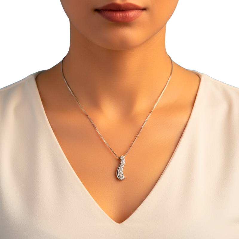 Silver necklace with a pendant on a model wearing a white top