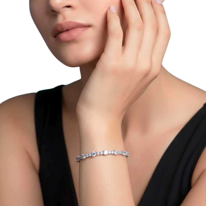 Close-up of a woman's hand wearing a silver bracelet on a white background