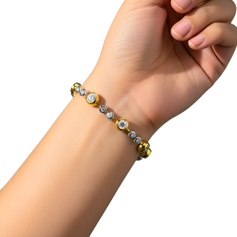 Hand wearing a gold and silver beaded bracelet on a white background