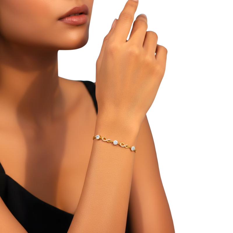 Gold bracelet with small pearls on a wrist against a white background