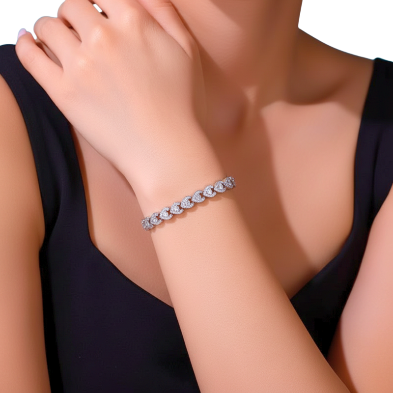 Bracelet with diamonds on a person's wrist against a neutral background