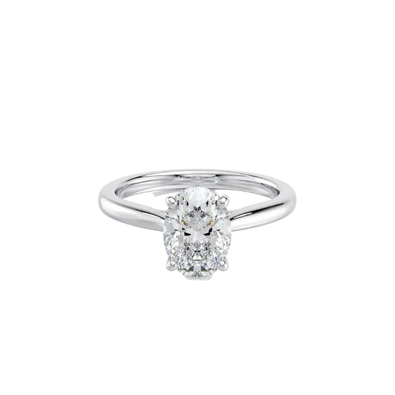 An oval-cut diamond solitaire engagement ring in a polished silver-colored metal band, set against a clean white background with a subtle reflection.