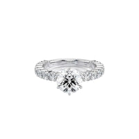An oval-cut diamond solitaire engagement ring set in a polished silver-colored band, shown on a clean white background with a soft reflection.