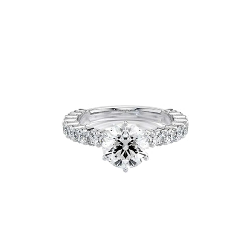 An oval-cut diamond solitaire engagement ring set in a polished silver-colored band, shown on a clean white background with a soft reflection.