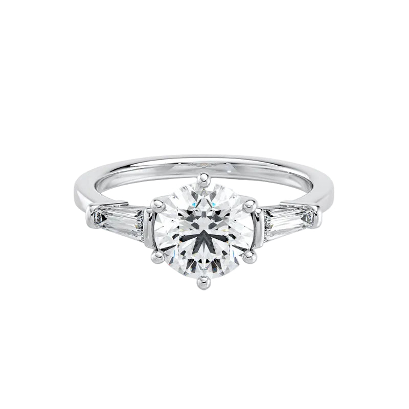 Diamond ring with a central gemstone and baguette side stones on a white background