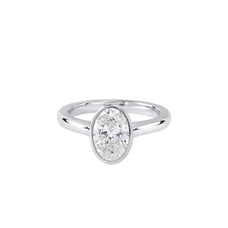 A silver engagement ring featuring a large oval-cut diamond in a bezel setting, shown on a clean white background.