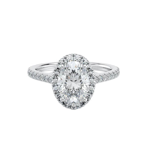 Diamond ring with a central oval-cut diamond and smaller diamonds around on a white background