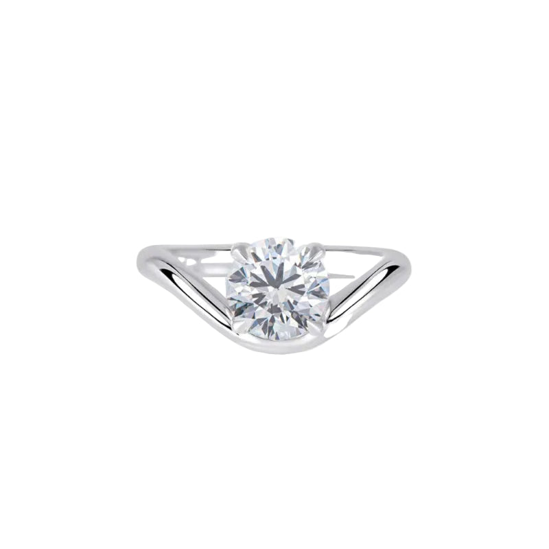 A silver solitaire engagement ring featuring a round brilliant-cut diamond center stone in a prong setting, set against a clean white background.