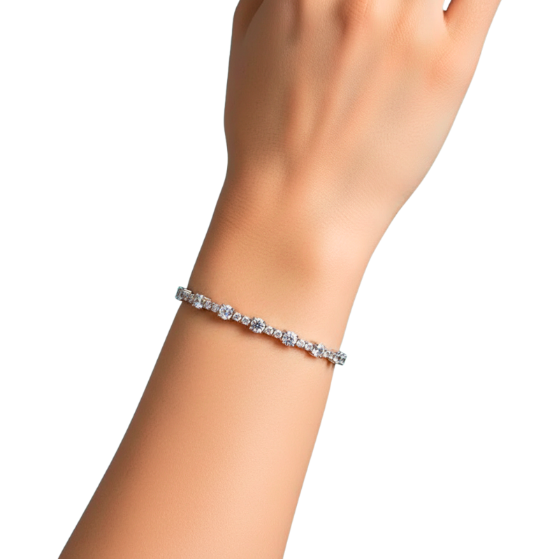 Silver bracelet on a wrist against a white background