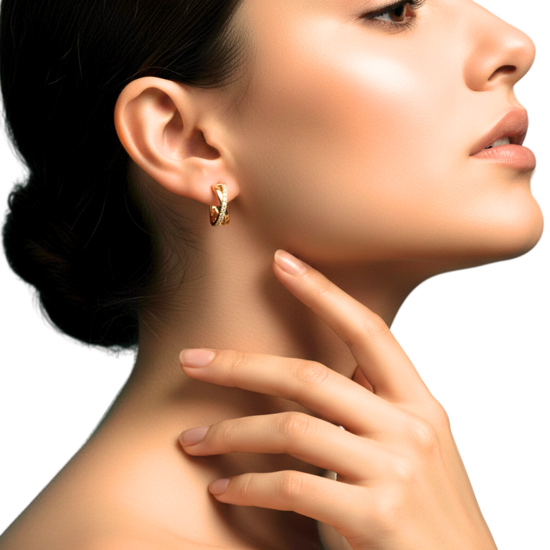 Close-up of a woman wearing gold hoop earrings with a neutral background