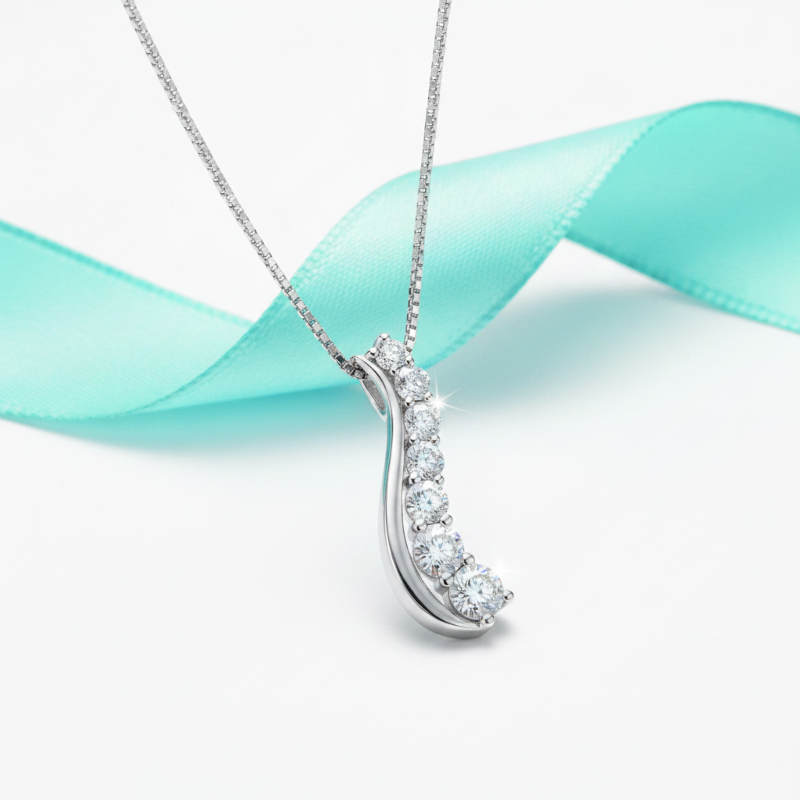 Diamond necklace on a white background with a teal ribbon
