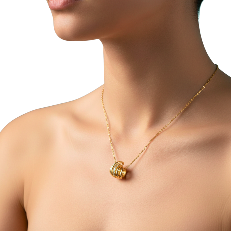 Gold necklace with a unique pendant on a model against a white background