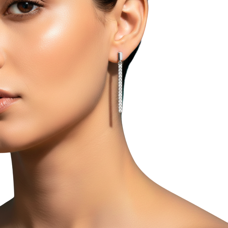 Close-up of a woman wearing a diamond earring on a white background