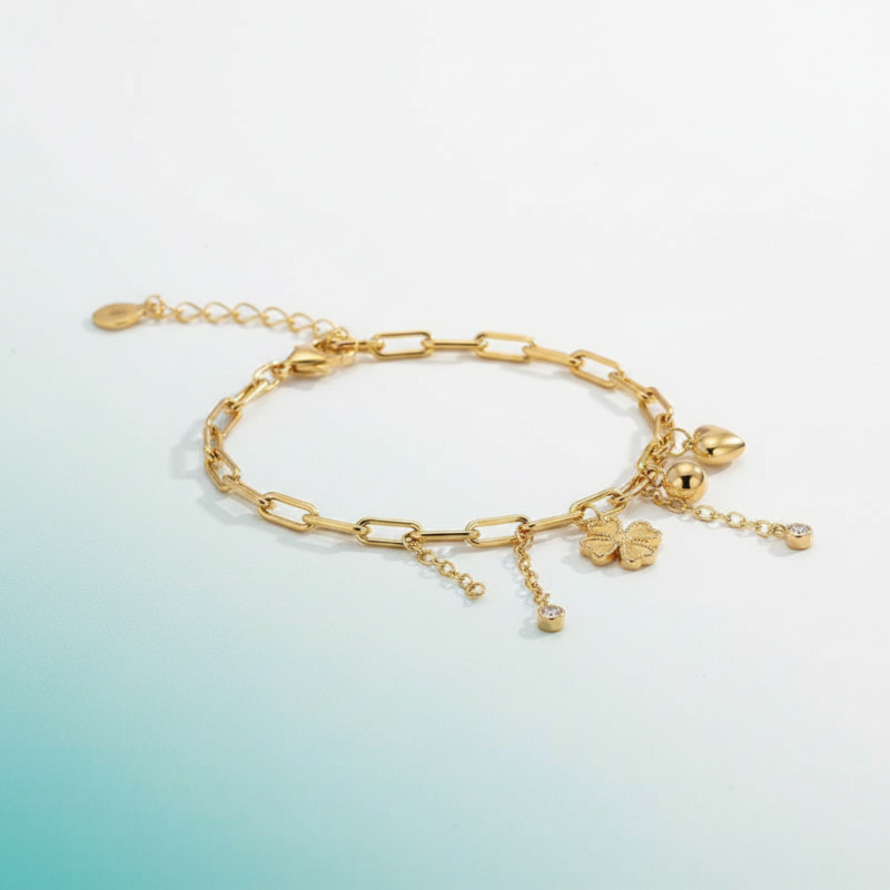 Gold bracelet with charms on a gradient background