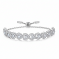 Silver bracelet with heart-shaped diamond designs on a white background