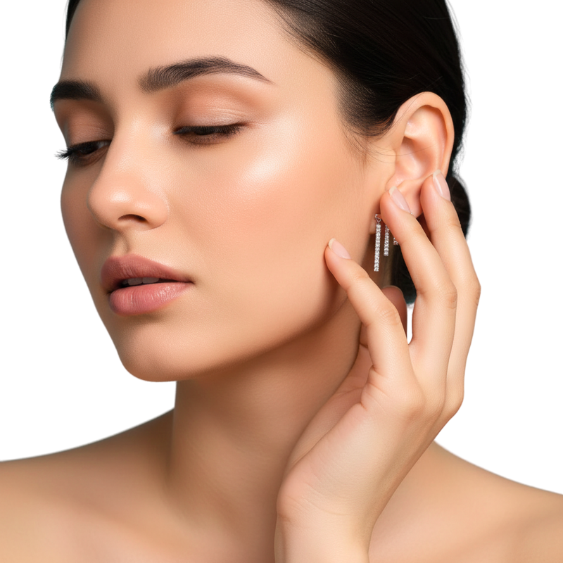 Woman adjusting an earring with a neutral background