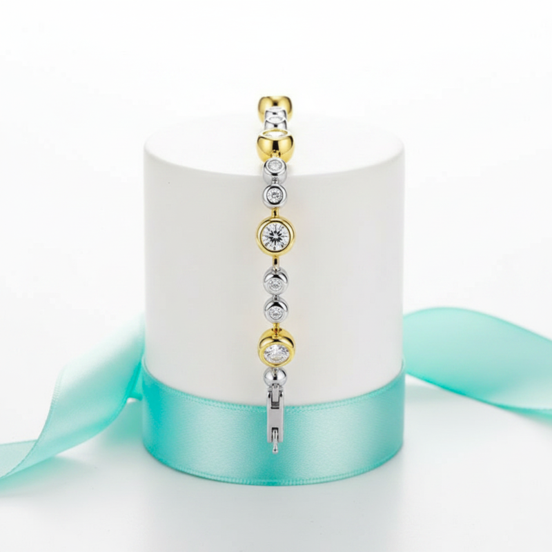 Jewelry set with gold and silver elements on a white box with a turquoise ribbon