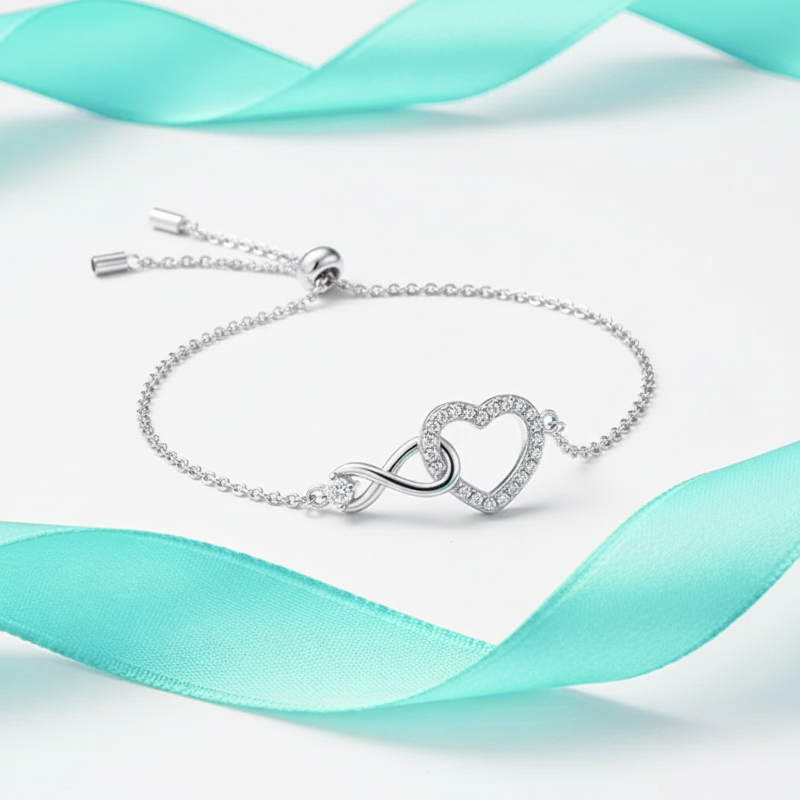 Silver bracelet with heart and infinity symbol on a light blue ribbon