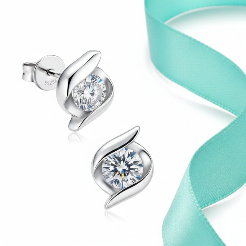 Silver earrings with clear gemstones on a white background