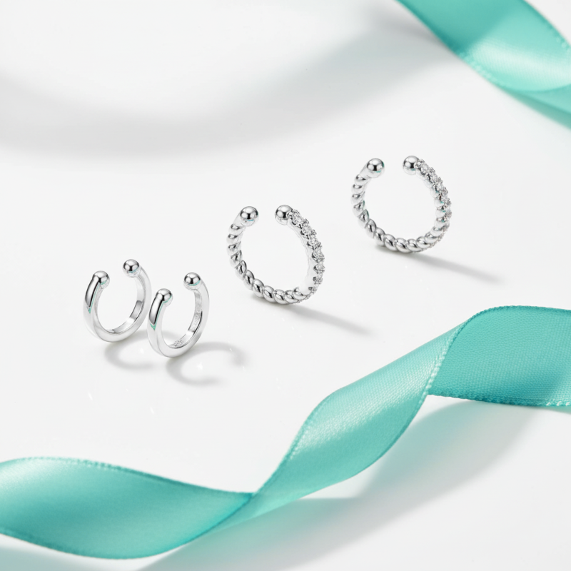 Silver hoop earrings with a turquoise ribbon on a light background