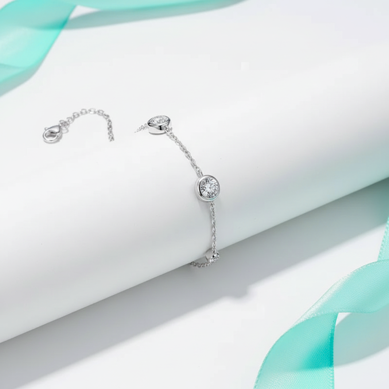 Silver earrings with a central gemstone on a light background