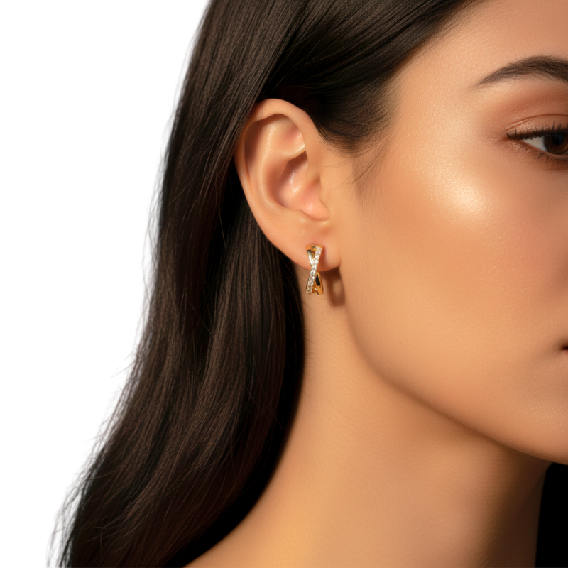 Close-up of a woman wearing gold earrings with a neutral background