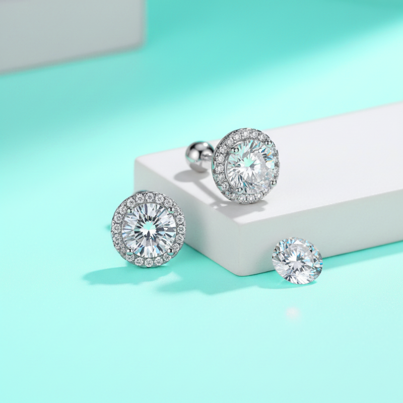 Silver earrings with clear gemstones on a light blue background