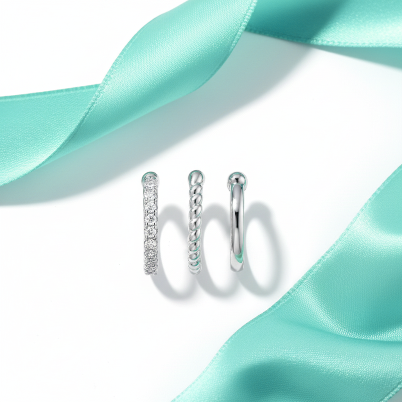 Silver hoop earrings on a light blue satin ribbon
