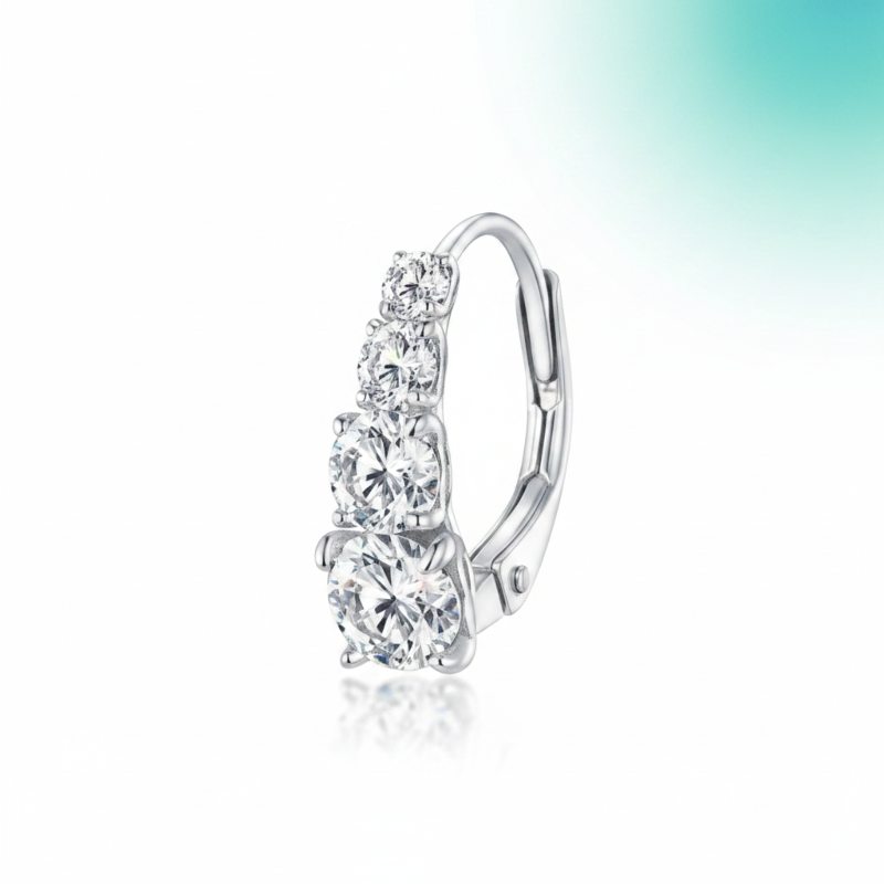 Silver earring with clear gemstones on a white background
