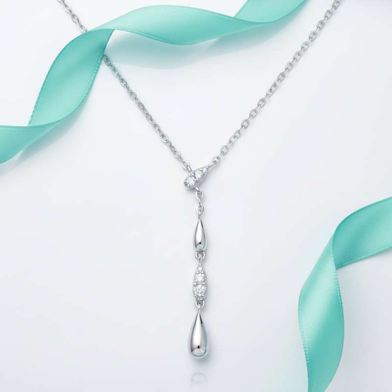 Silver necklace with a pendant on a light blue ribbon background