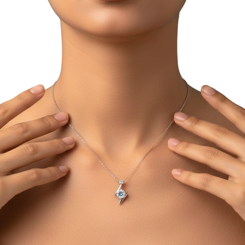 Necklace with a pendant worn by a person, hands touching the neckline