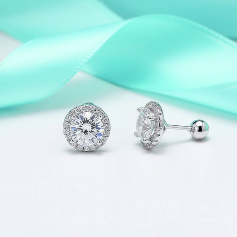 Silver earrings with clear gemstones on a light blue and white background