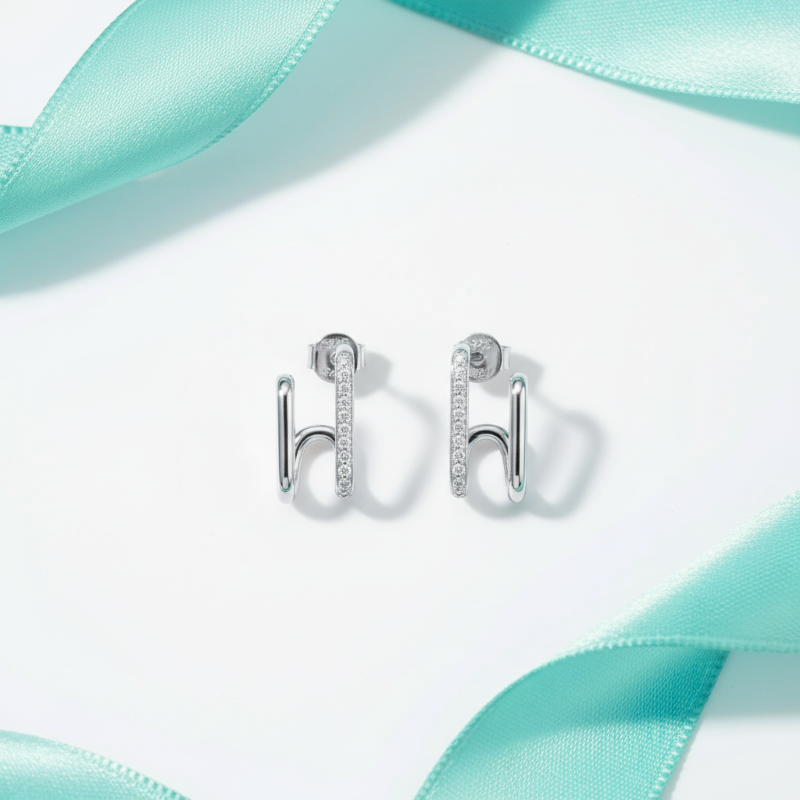 Silver earrings with a turquoise ribbon on a white background