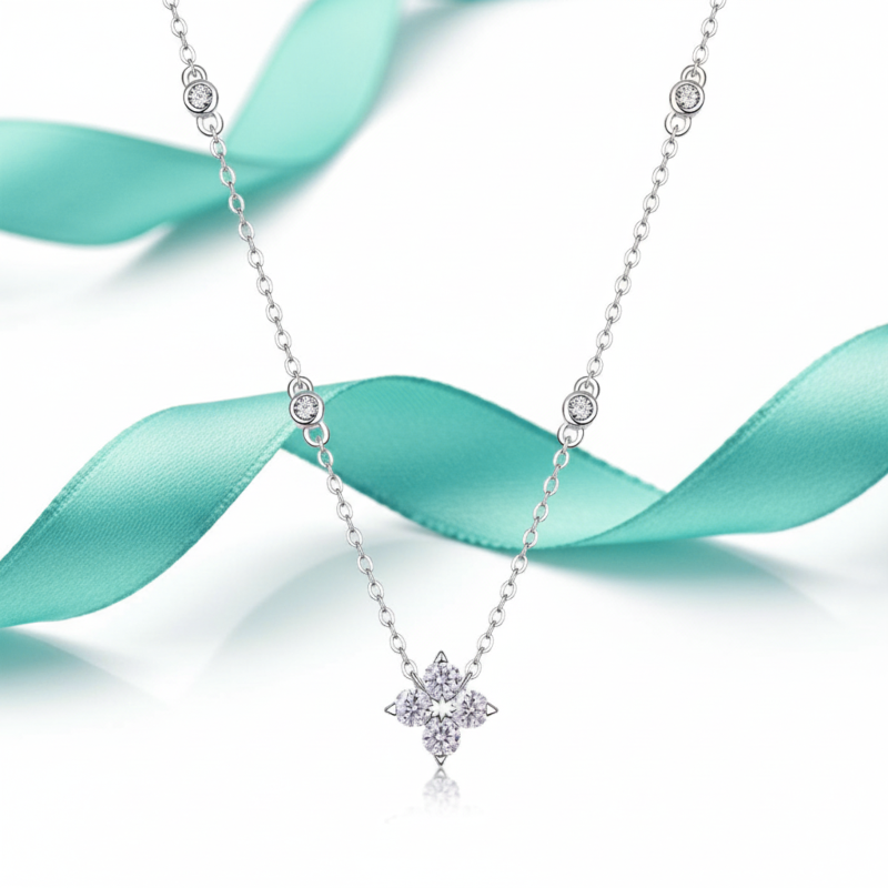 Silver necklace with a star-shaped pendant on a light blue ribbon background