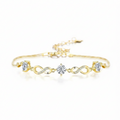 Gold bracelet with infinity and heart designs on a white background