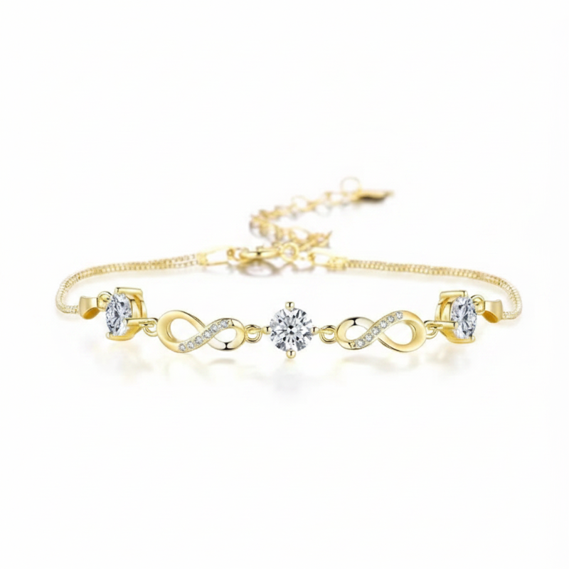 Gold bracelet with infinity and heart designs on a white background