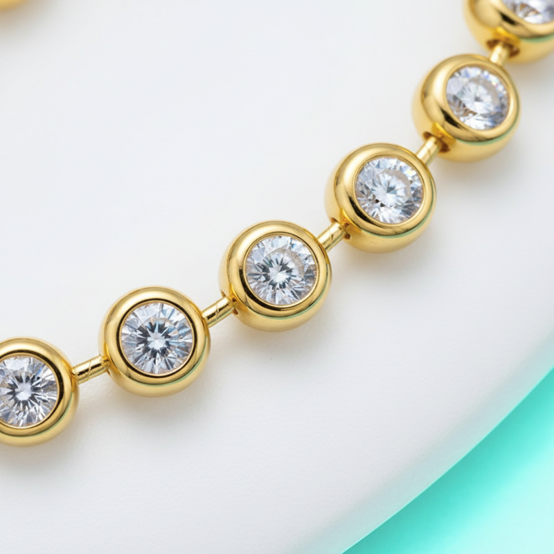 Gold bracelet with clear gemstones on a light background